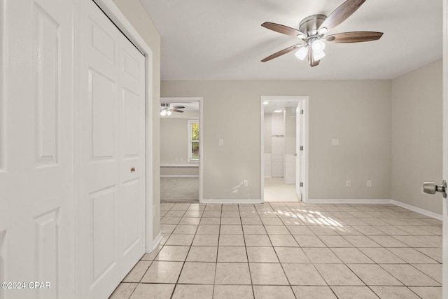 tiled empty room with ceiling fan