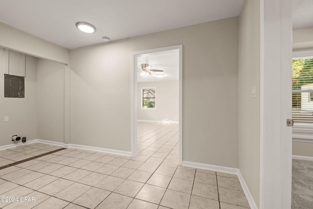 washroom with ceiling fan, light tile patterned flooring, plenty of natural light, and electric panel