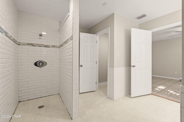 bathroom with tile patterned floors and tiled shower