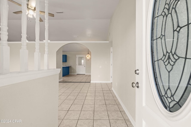 tiled foyer entrance with vaulted ceiling and ceiling fan