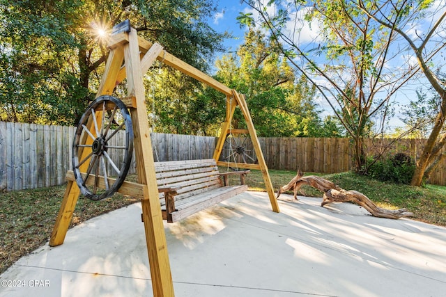 view of playground with a patio