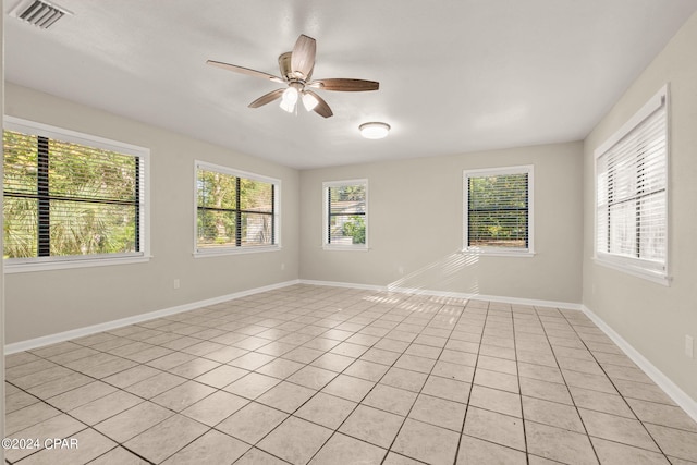 spare room with light tile patterned floors and ceiling fan