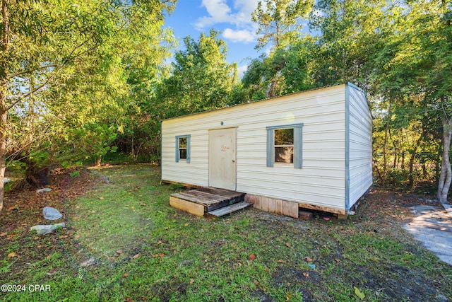 view of outbuilding featuring a yard