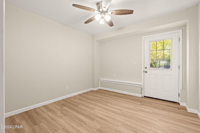 empty room featuring light wood-type flooring and ceiling fan