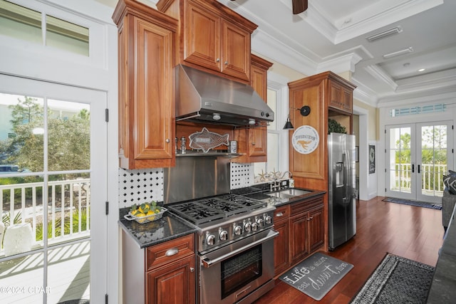 kitchen with stainless steel appliances, dark hardwood / wood-style floors, a healthy amount of sunlight, and range hood