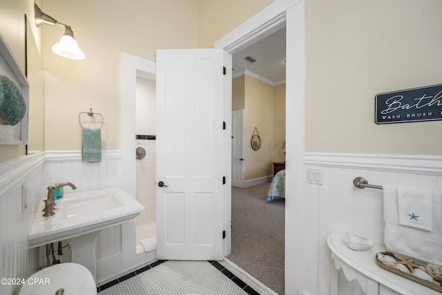 bathroom with tile patterned floors and crown molding