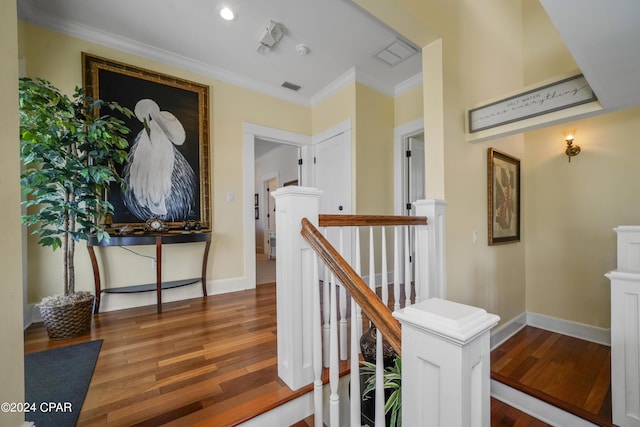 hall with ornamental molding and dark wood-type flooring