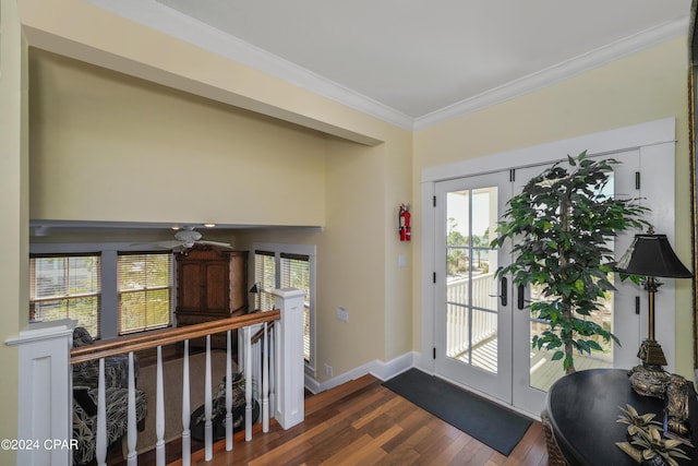 foyer entrance with crown molding, dark wood-type flooring, a wealth of natural light, and french doors