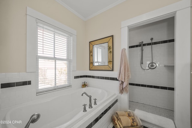 bathroom featuring a wealth of natural light, a relaxing tiled tub, and ornamental molding