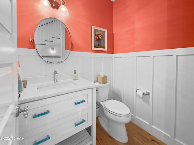 bathroom featuring vanity, hardwood / wood-style flooring, and toilet