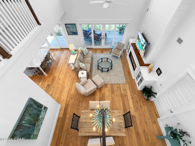 bedroom with access to exterior, french doors, light wood-type flooring, and ceiling fan