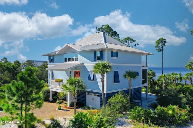 view of front of property with a water view and a garage