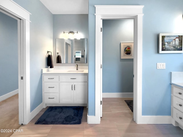 bathroom with vanity and wood-type flooring