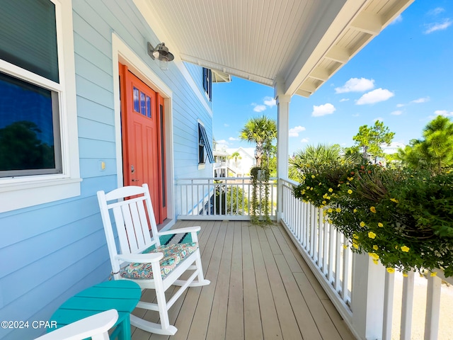 wooden terrace featuring covered porch