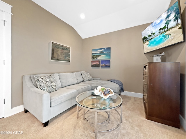 carpeted living room featuring vaulted ceiling