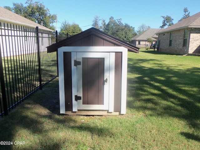 view of outbuilding featuring a lawn