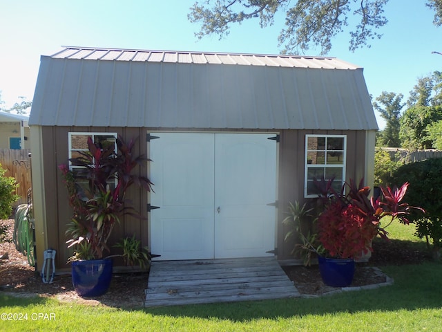 view of outbuilding featuring a lawn