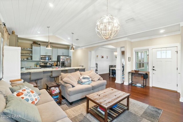 living room featuring dark hardwood / wood-style flooring, sink, a chandelier, decorative columns, and wooden ceiling