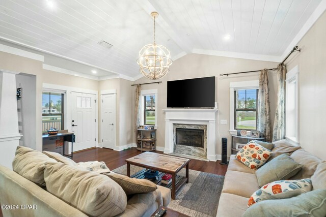 living room with lofted ceiling, a high end fireplace, plenty of natural light, and dark hardwood / wood-style floors