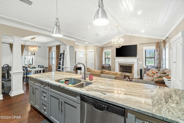 kitchen with decorative light fixtures, dishwasher, sink, dark hardwood / wood-style flooring, and light stone counters