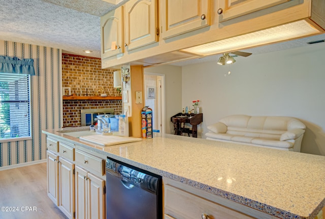 kitchen featuring light wood-type flooring, light stone counters, a textured ceiling, ceiling fan, and dishwasher