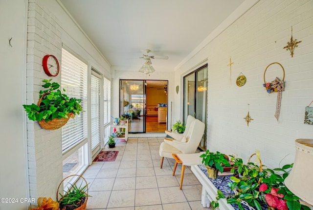 sunroom / solarium featuring ceiling fan