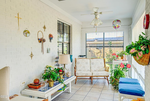 sunroom featuring ceiling fan and a healthy amount of sunlight