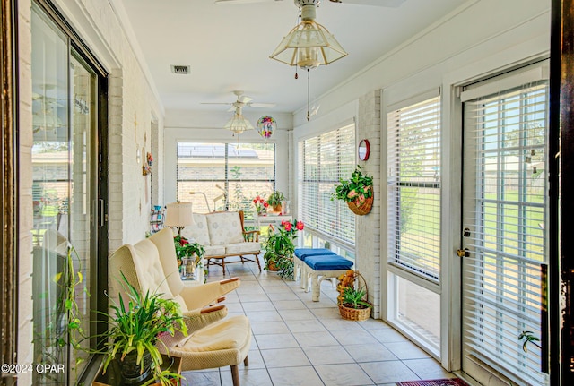 sunroom with ceiling fan and plenty of natural light