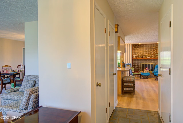 hallway with a textured ceiling