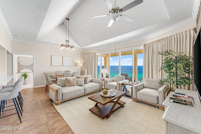 living room featuring ornamental molding, ceiling fan with notable chandelier, a textured ceiling, light parquet floors, and a water view