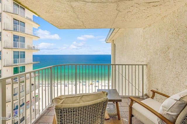 balcony with a view of the beach and a water view