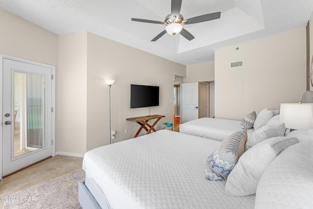 bedroom with a textured ceiling, access to outside, ceiling fan, and light tile patterned flooring