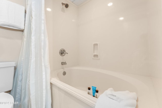 bathroom with toilet and shower / tub combo with curtain