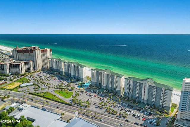 bird's eye view featuring a water view and a beach view