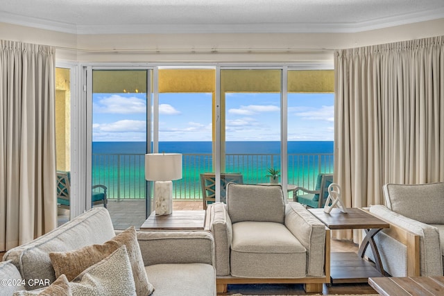 interior space featuring crown molding, a water view, and a textured ceiling