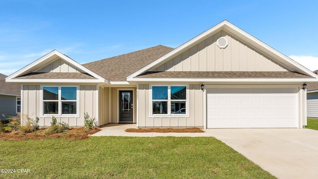 view of front of house with a garage and a front lawn