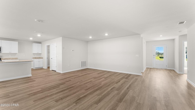 unfurnished living room featuring light wood-type flooring