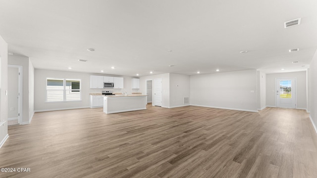 unfurnished living room with light hardwood / wood-style flooring