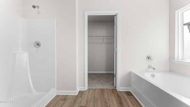 bathroom featuring wood-type flooring and independent shower and bath