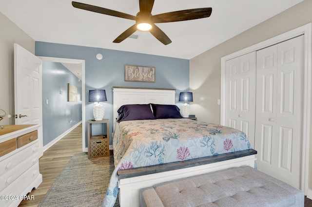 bedroom featuring light hardwood / wood-style floors, a closet, and ceiling fan