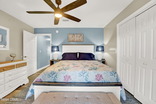 bedroom featuring a closet, dark wood-type flooring, and ceiling fan