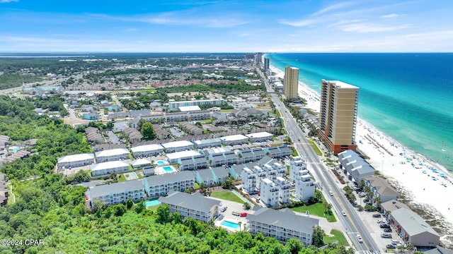 birds eye view of property with a water view and a view of the beach