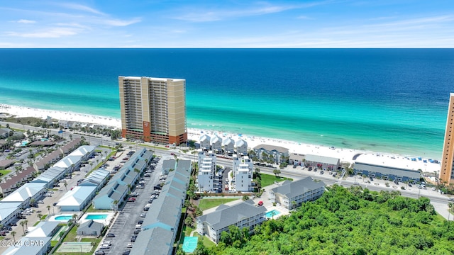 birds eye view of property with a water view and a view of the beach