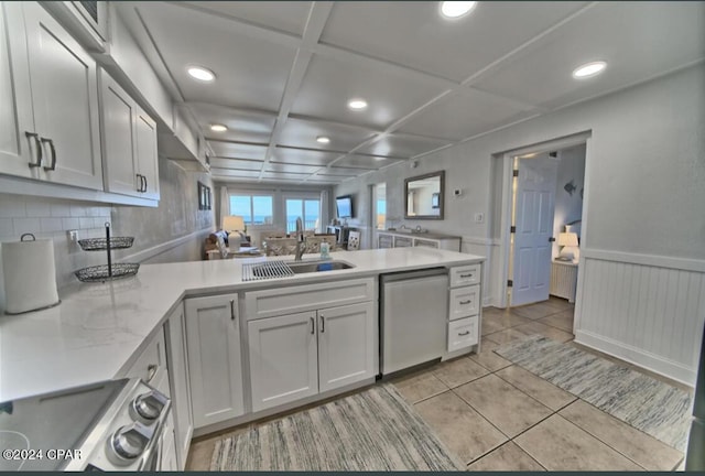 kitchen with white cabinetry, sink, stainless steel appliances, and coffered ceiling