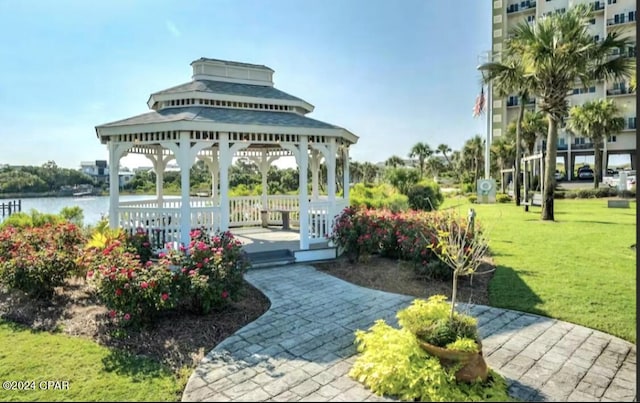 view of community featuring a gazebo, a yard, and a water view