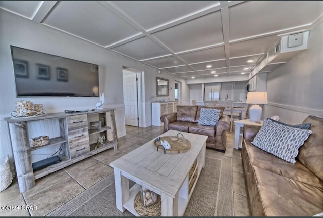 living room featuring light tile patterned floors and coffered ceiling