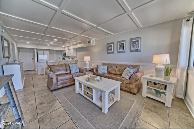 living room with light tile patterned floors and coffered ceiling