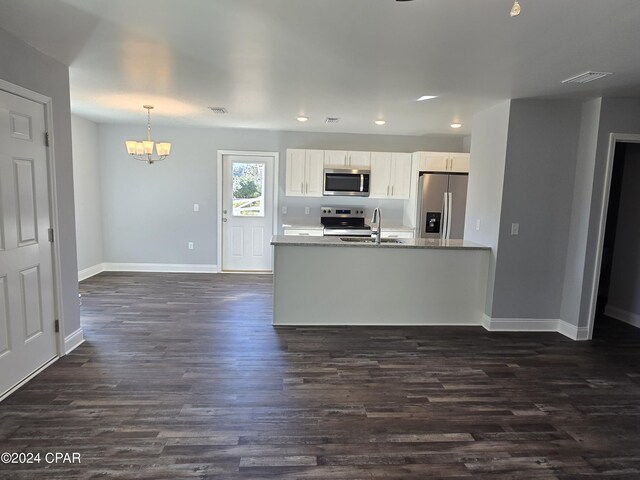 kitchen with light stone counters, white cabinets, and stainless steel appliances