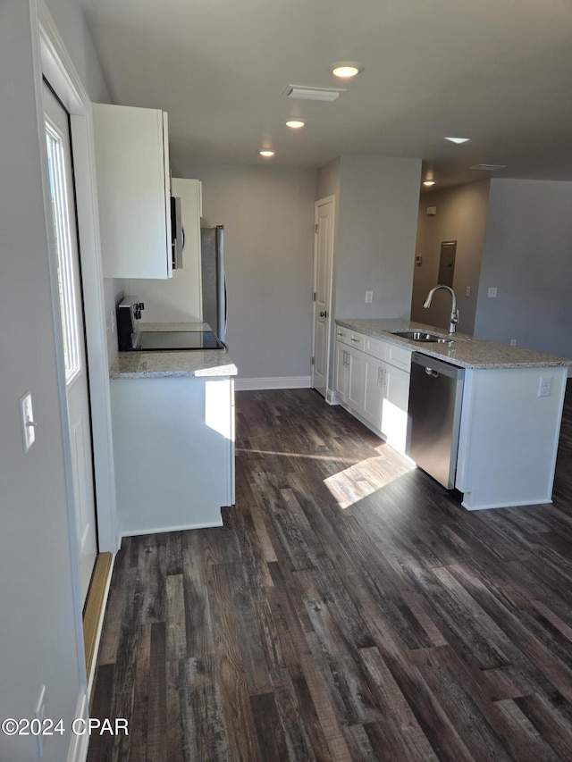 kitchen with white cabinetry, sink, dark wood-type flooring, kitchen peninsula, and appliances with stainless steel finishes