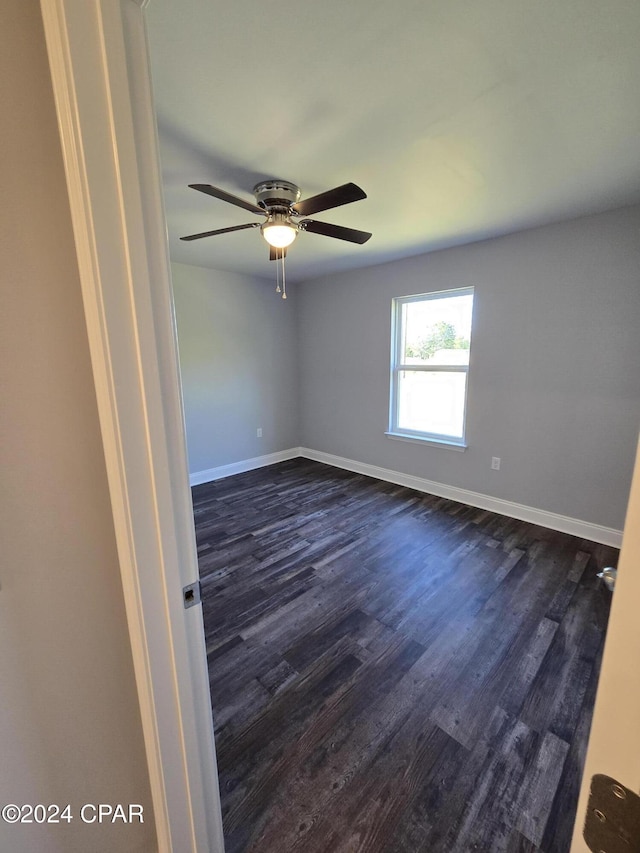 unfurnished room featuring dark hardwood / wood-style floors and ceiling fan